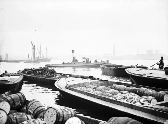 Framed Print : Steam tug moving between barges on the Thames, London, c1905 Framed Print : Steam tug moving between barges on the Thames, London, c1905