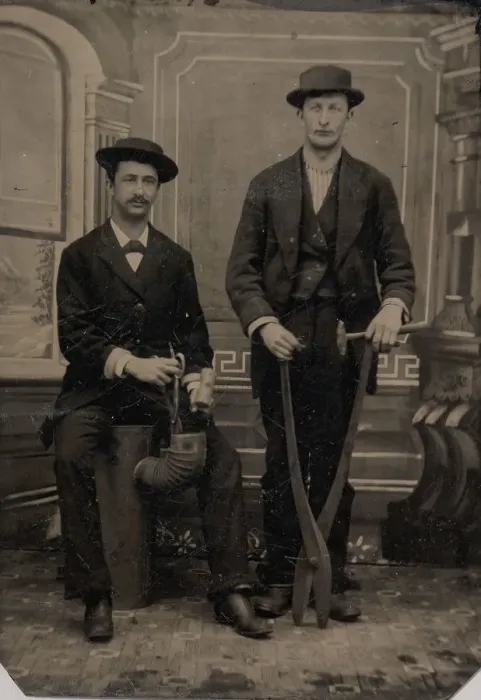Framed Print : Two Stovepipe Makers, One with a Hammer and Tin Snips... 1880s. Creator: Unknown Framed Print : Two Stovepipe Makers, One with a Hammer and Tin Snips... 1880s. Creator: Unknown