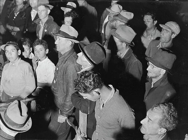 Street meeting at night in Mexican town outside of Shafter, California, 1938. Creator: Dorothea Lange