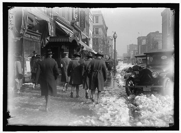 Street scene, with snow, Washington, D.C. between 1913 and 1918. Creator: Harris & Ewing. Street scene, with snow, Washington, D.C. between 1913 and 1918. Creator: Harris & Ewing