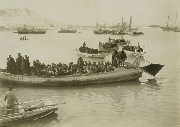 String of pontoons in tow of stream launch, approaching landing stage, Chemulpo, c1904. Creator: Robert Lee Dunn