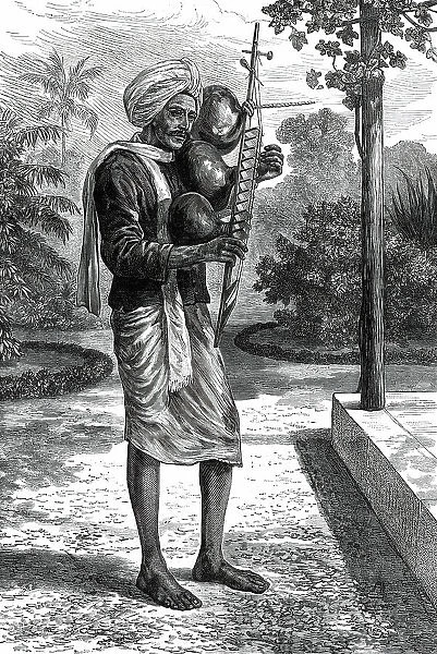 A strolling minstrel at Madras playing the tingadee, 1876. Creator: Unknown
