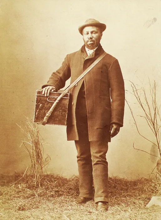 Framed Print : Studio portrait of man holding box labelled Confectionery, c1880. Creator: William Notman Framed Print : Studio portrait of man holding box labelled Confectionery, c1880. Creator: William Notman