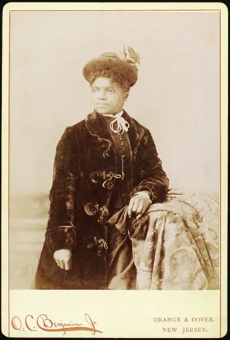 Framed Print : Studio portrait of woman wearing hat, and velvet coat, c1880-c1889. Creators: O.C. Benjamin, Unknown Framed Print : Studio portrait of woman wearing hat, and velvet coat, c1880-c1889. Creators: O.C. Benjamin, Unknown