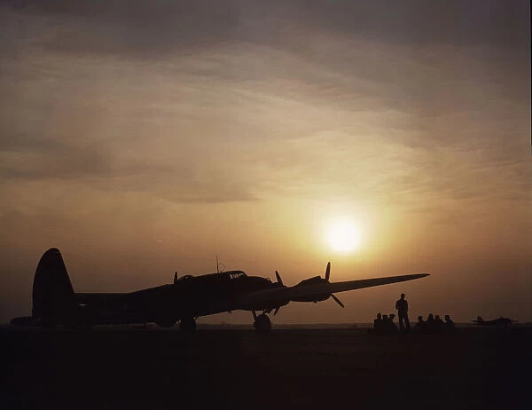 Sunset silhouette of flying fortress, Langley Field, Va. 1942. Creator: Alfred T Palmer