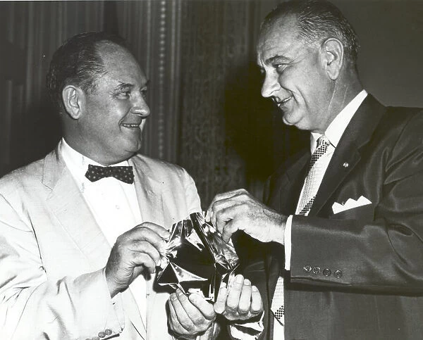 T. Keith Glennan shows Lyndon Johnson aluminized mylar flim used to make the Echo I