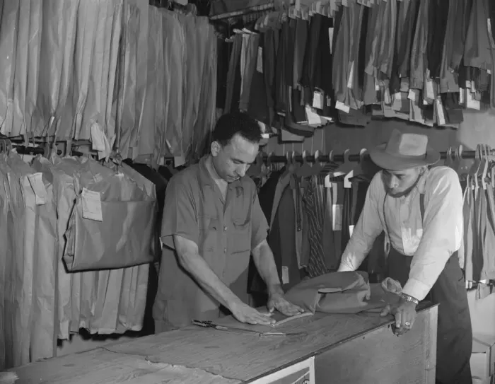 Framed Print : A tailor in Franks cleaning and pressing establishment altering... Washington, D.C. 1942. Creator: Gordon Parks Framed Print : A tailor in Franks cleaning and pressing establishment altering... Washington, D.C. 1942. Creator: Gordon Parks