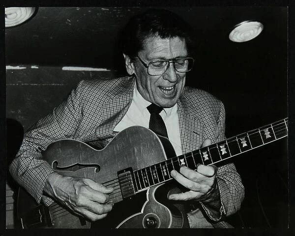 Tal Farlow playing the guitar at The Bell, Codicote, Hertfordshire, 18 May 1986. Artist