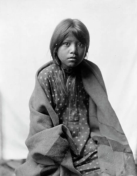 A Taos girl, three-quarter length portrait, seated, facing front, c1905. Creator: Edward Sheriff Curtis