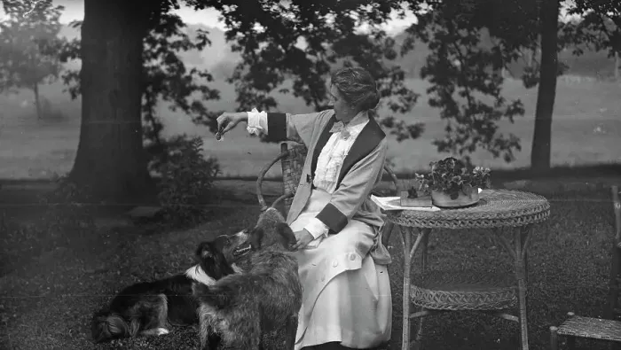 Framed Print : Tarbell, Ida, Miss, with dogs, seated outdoors, 1912 or 1913. Creator: Arnold Genthe Framed Print : Tarbell, Ida, Miss, with dogs, seated outdoors, 1912 or 1913. Creator: Arnold Genthe