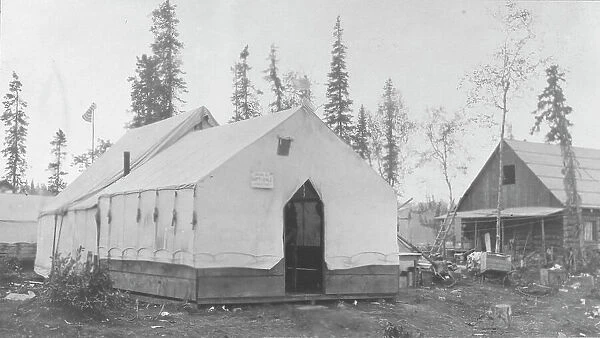 Tent next to log cabin, between c1900 and 1916. Creator: Unknown