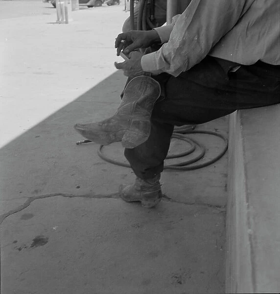 A Texas cattleman is distinguished by the type of boot he wears, Van Horn, Texas, 1937. Creator: Dorothea Lange