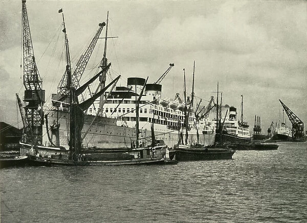 'The Forest of Masts Has Given Place to a Cluster of Steamer Funnels' Vessels Berthed at... 1937. Creator: Unknown. 'The Forest of Masts Has Given Place to a Cluster of Steamer Funnels' Vessels Berthed at... 1937. Creator: Unknown