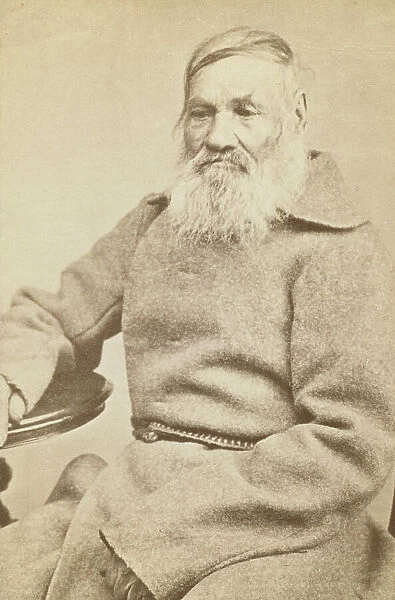 Three-quarter length portrait of an elderly convict, facing slightly left, between 1880 and 1886. Creator: Unknown