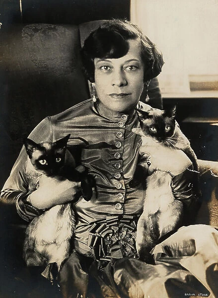 Tilla Durieux with two Siamese cats, 1920s. Creator: Stone, Sasha (1895-1940)