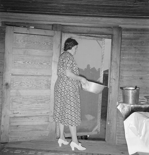 Tobacco sharecroppers wife disposing of dishwater... Person County, North Carolina, 1939. Creator: Dorothea Lange