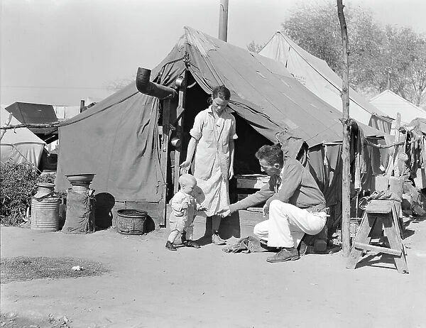 Tom Collins, manager of Kern migrant camp, with drought refugee family, California, 1936. Creator: Dorothea Lange