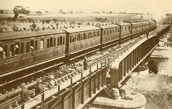A Train Passing Over The Bridge, c1930. Creator: Unknown