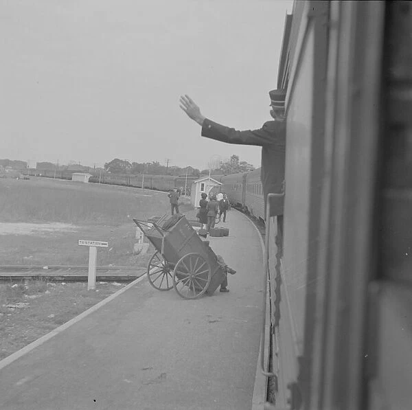 Trainman signalling from a 'Jim Crow'coach, Saint Augustine, Florida, 1943. Creator: Gordon Parks