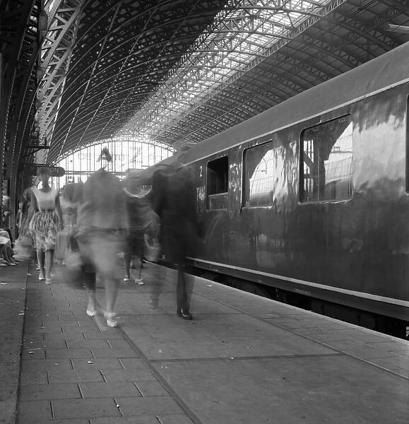 Travellers walking along a platform at Centraal Station, Amsterdam, Netherlands, 1963