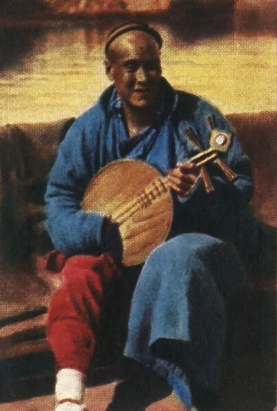 Travelling musician, China, c1928. Creator: Unknown