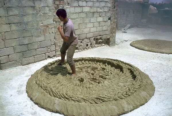 Treading clay for pottery in Tunisia. Artist: CM Dixon