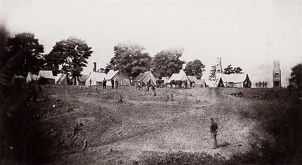 [Unidentified camp with ruined chimneys in background]. Brady album, p. 130, 1861-65