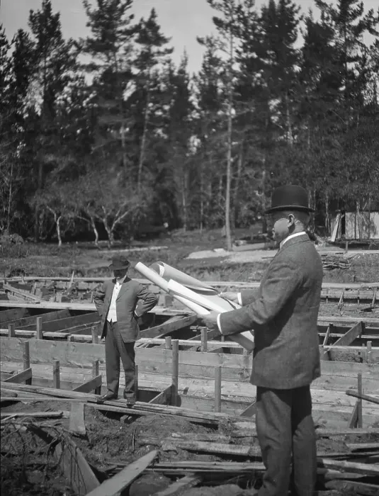 Framed Print : Unidentified man at a construction site studying building plans, between 1896 and 1942. Creator: Arnold Genthe Framed Print : Unidentified man at a construction site studying building plans, between 1896 and 1942. Creator: Arnold Genthe