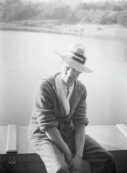 Unidentified man, seated in front of water, between 1896 and 1942. Creator: Arnold Genthe