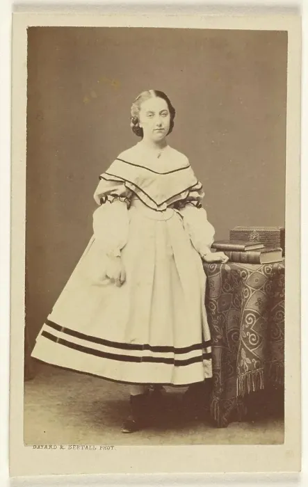 Framed Print : Unidentified woman standing near a table with books on top, 1865-1875. Creator: Bayard & Bertall Framed Print : Unidentified woman standing near a table with books on top, 1865-1875. Creator: Bayard & Bertall
