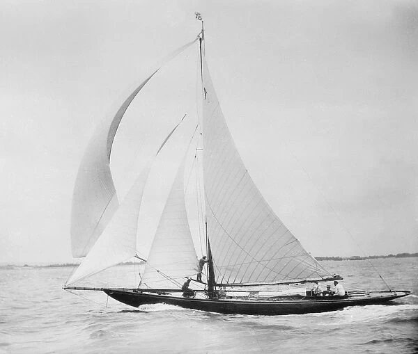 Unknown cutter sailing with spinnaker. Creator: Kirk & Sons of Cowes
