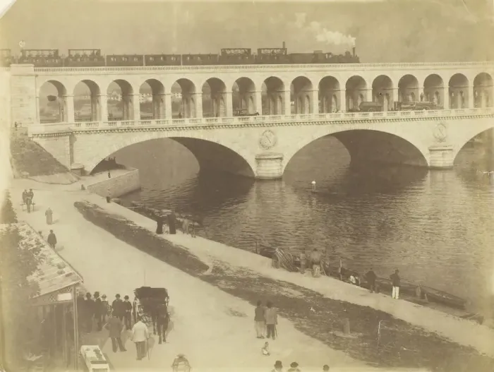 Framed Print : Untitled, 1870  /  79. [Steam locomotive on the upper level of a bridge... ]. Creator: Unknown