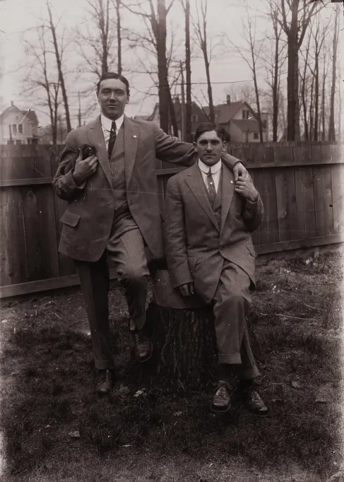 Framed Print : Untitled (two men holding small dog; one sitting on a stump, Fisher St. backyard), c1915. Creator: Wendell Hotter Framed Print : Untitled (two men holding small dog; one sitting on a stump, Fisher St. backyard), c1915. Creator: Wendell Hotter