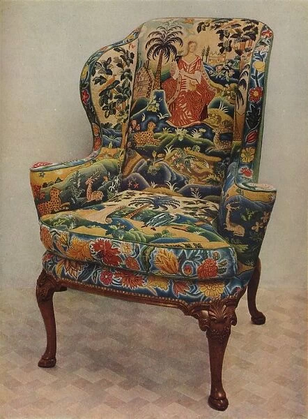 An upholstered armchair with wings, carved walnut frame and original silk needlework covering, c17