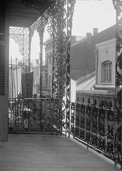Upper level balconies with wrought iron on St. Peter Street, New Orleans, between 1920 and 1926. Creator: Arnold Genthe