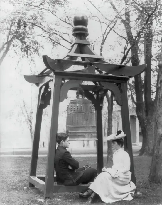 Framed Print : U.S. Naval Academy, Annapolis, Md. 1902?: midshipman and girl sitting beneath bell, (1902?). Creator: Frances Benjamin Johnston Framed Print : U.S. Naval Academy, Annapolis, Md. 1902?: midshipman and girl sitting beneath bell, (1902?). Creator: Frances Benjamin Johnston