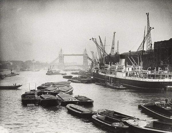View of the busy Thames looking towards Tower Bridge, London, c1920