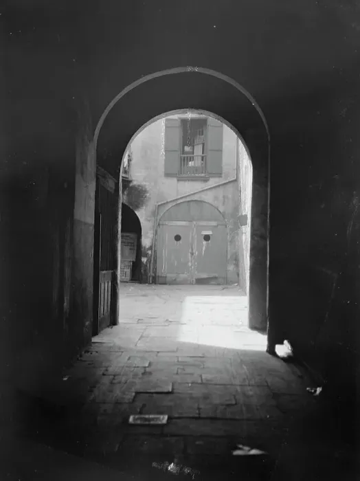 Framed Print : View of a courtyard through an arched passageway, New Orleans, between 1920 and 1926. Creator: Arnold Genthe Framed Print : View of a courtyard through an arched passageway, New Orleans, between 1920 and 1926. Creator: Arnold Genthe