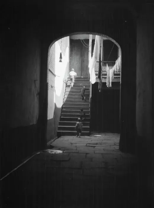Framed Print : View of a courtyard through an arched passageway, New Orleans, between 1920 and 1926. Creator: Arnold Genthe Framed Print : View of a courtyard through an arched passageway, New Orleans, between 1920 and 1926. Creator: Arnold Genthe