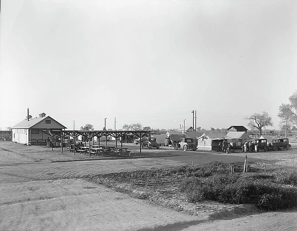 View of Kern migrant camp showing outdoor clubroom with protection from the sun, California, 1936. Creator: Dorothea Lange