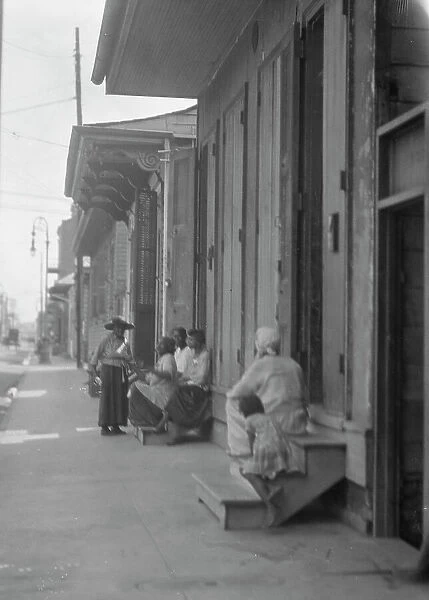 View down a sidewalk, New Orleans, between 1920 and 1926. Creator: Arnold Genthe