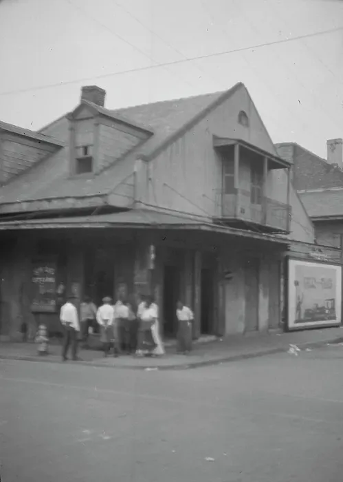 Framed Print : View from across street of a group of men on a street corner, New Orleans, between 1920 and 1926. Creator: Arnold Genthe Framed Print : View from across street of a group of men on a street corner, New Orleans, between 1920 and 1926. Creator: Arnold Genthe