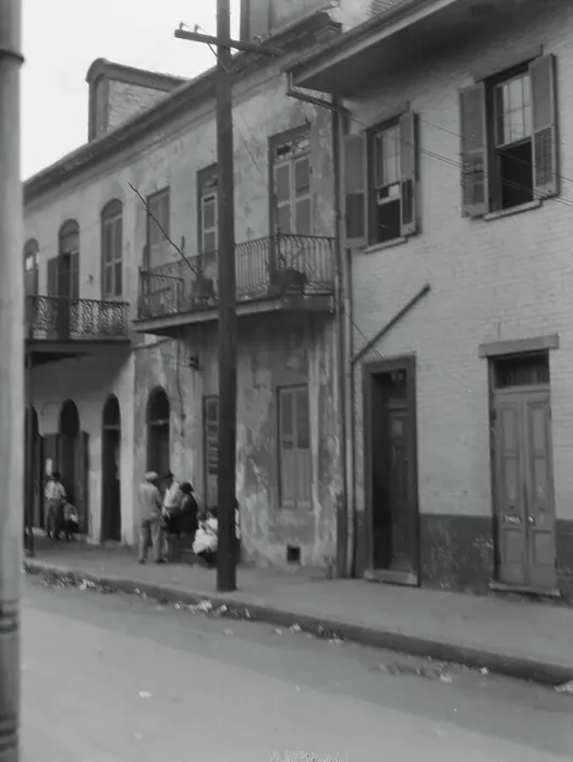 Framed Print : View from across street of four people talking in the French Quarter, New Orleans, c1920-1926. Creator: Arnold Genthe Framed Print : View from across street of four people talking in the French Quarter, New Orleans, c1920-1926. Creator: Arnold Genthe