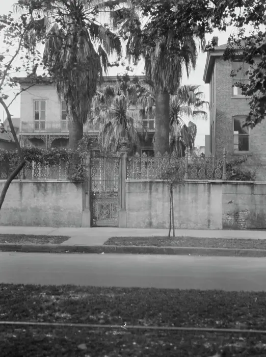 Framed Print : View from across street of two-story house behind wall, New Orleans, between 1920 and 1926. Creator: Arnold Genthe