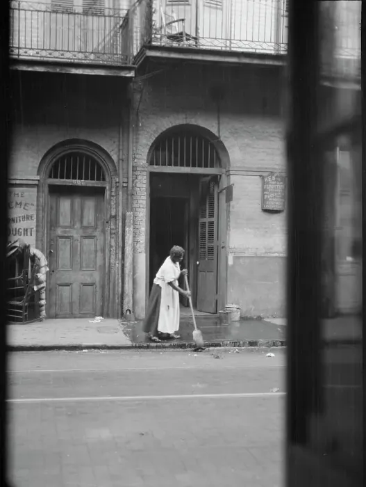 Framed Print : View from across street of a woman cleaning the sidewalk, New Orleans, between 1920 and 1926. Creator: Arnold Genthe Framed Print : View from across street of a woman cleaning the sidewalk, New Orleans, between 1920 and 1926. Creator: Arnold Genthe