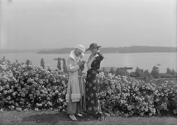 Viola Kraus and Helen Freeman standing outdoors, 1915 June. Creator: Arnold Genthe