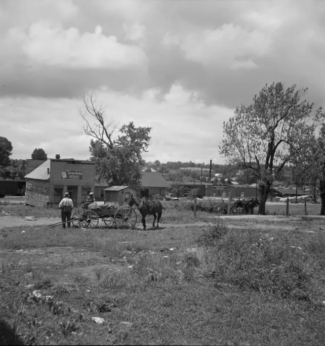 Framed Print : Wagons pulled up in field one block away from the main street, Siler City, North Carolina, 1939. Creator: Dorothea Lange Framed Print : Wagons pulled up in field one block away from the main street, Siler City, North Carolina, 1939. Creator: Dorothea Lange