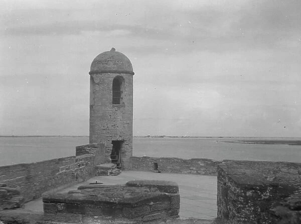 Walls and round tower by the water, Castillo de San Marcos, St. Augustine, Florida, c1920-c1926. Creator: Arnold Genthe