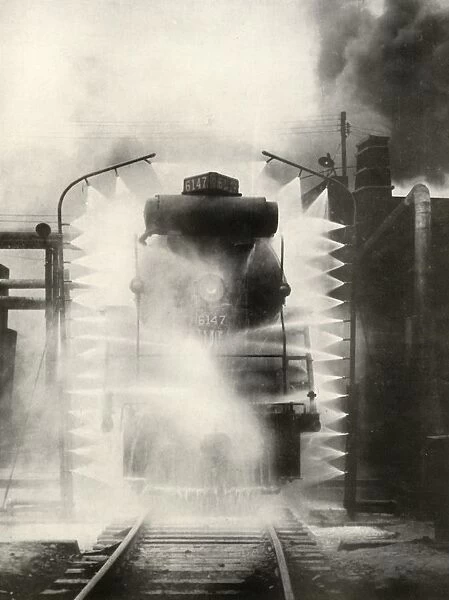 Washing A Locomotive on the Canadian National Railway, at Montrea, 1935. Creator: Unknown