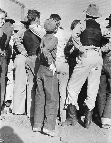 Watching ball game, Shafter migrant camp, California, 1938. Creator: Dorothea Lange